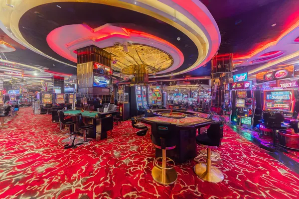 A close-up shot of golden coins falling around a spinning roulette wheel, representing immersive casino action at 588WIM.